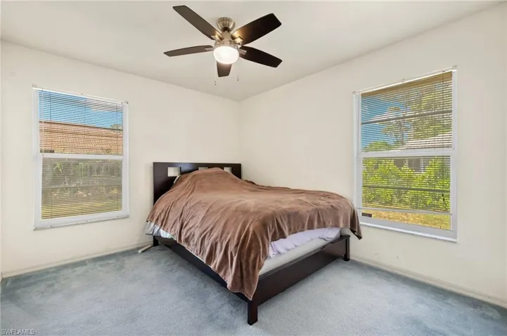 Bedroom featuring ceiling fan and carpet floors