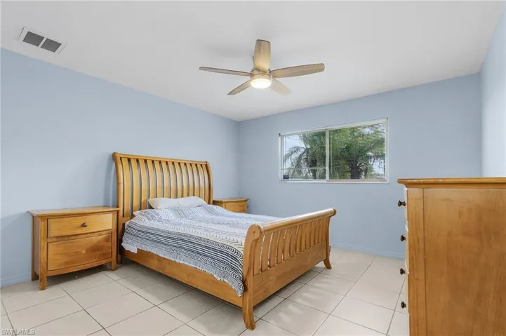 Bedroom featuring ceiling fan and light tile patterned flooring