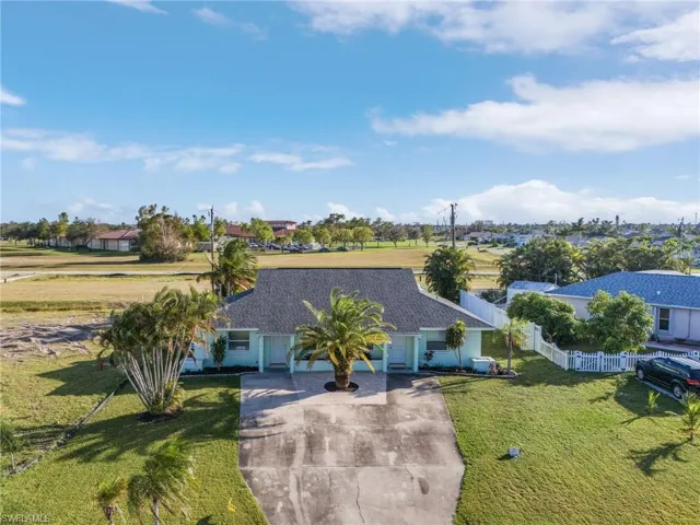 View of front of home with driveway and a residential view