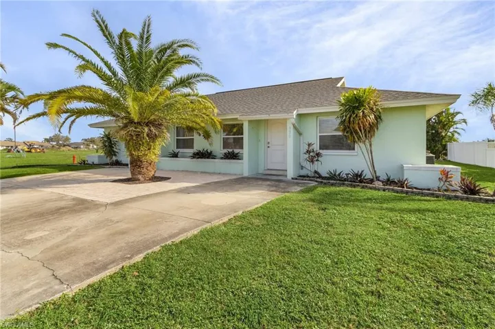 Single story home featuring roof with shingles, stucco siding, and concrete driveway