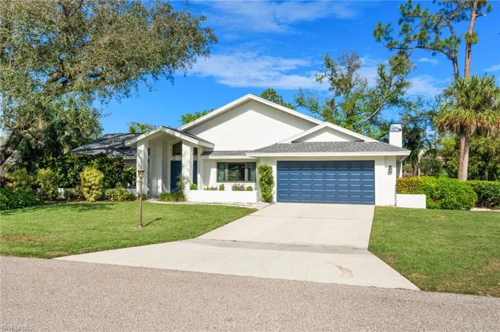 Ranch-style house with a front lawn and a garage