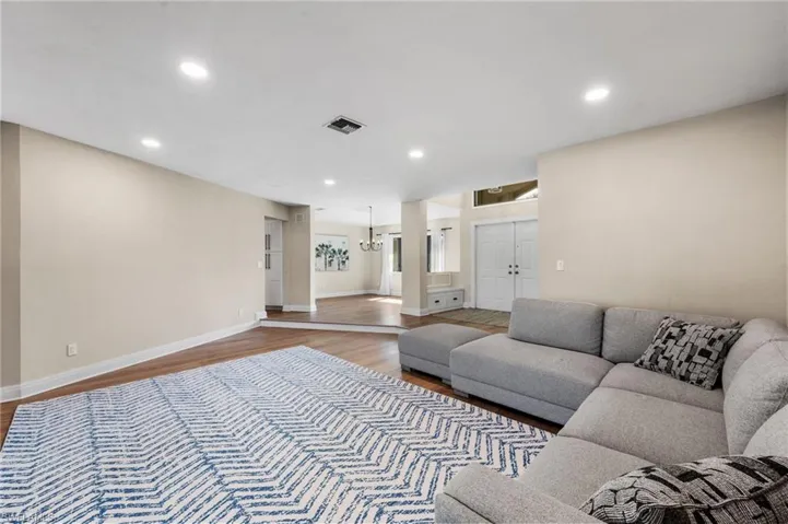 Living room featuring hardwood / wood-style flooring and a notable chandelier