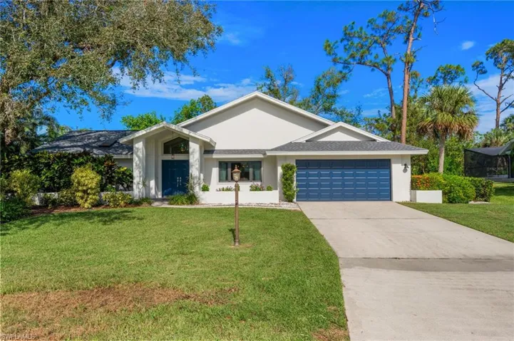 Single story home with a front yard and a garage