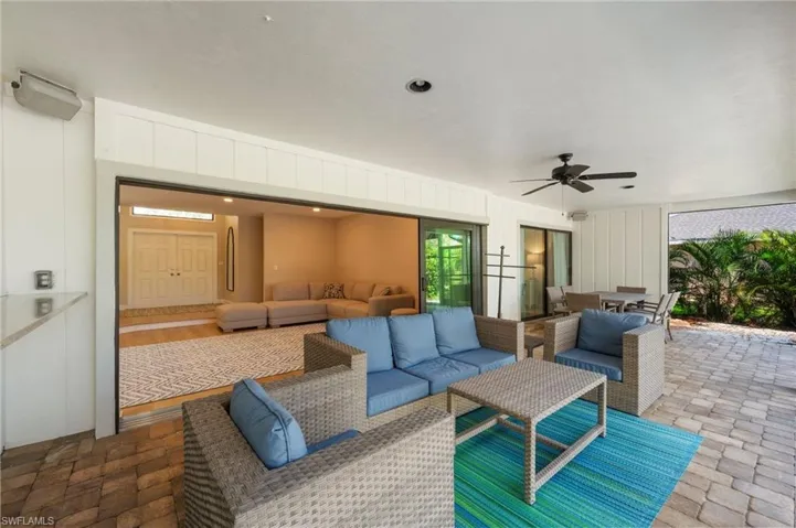 View of patio featuring an outdoor living space and ceiling fan