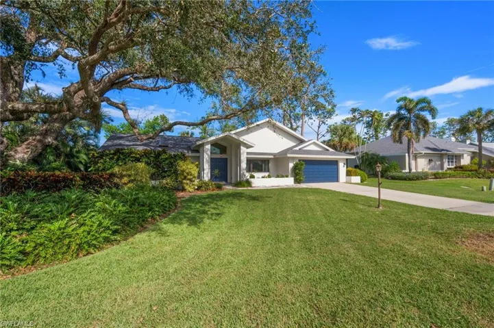 Ranch-style house with a garage and a front yard
