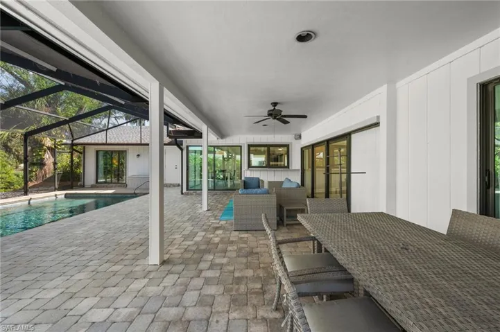 View of patio / terrace featuring a lanai, outdoor lounge area, and ceiling fan