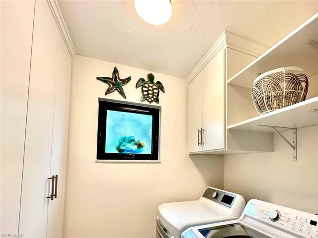 Laundry area with cabinet space and independent washer and dryer