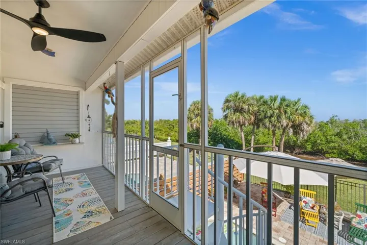Sunroom with vaulted ceiling and view of wooded area