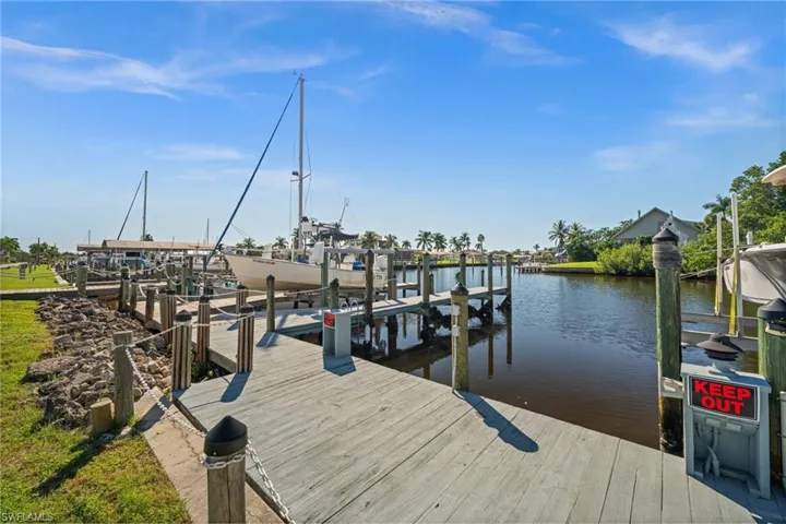 Dock area featuring boat lift and a water view