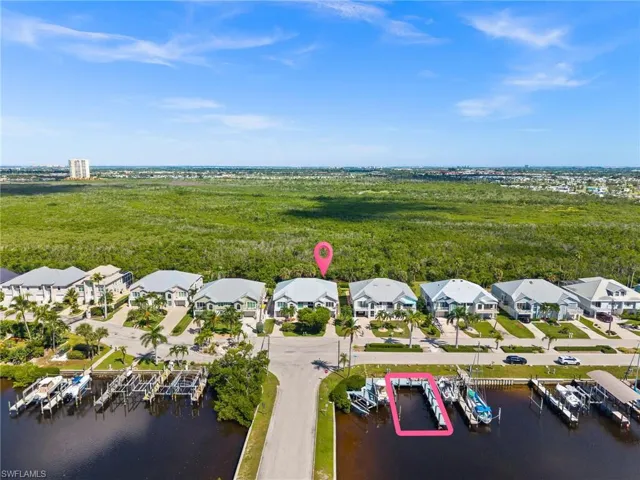 Aerial overview of property's location with a large body of water and a marina
