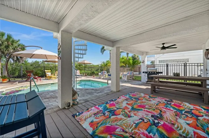 Deck with a patio, a ceiling fan, and area for grilling