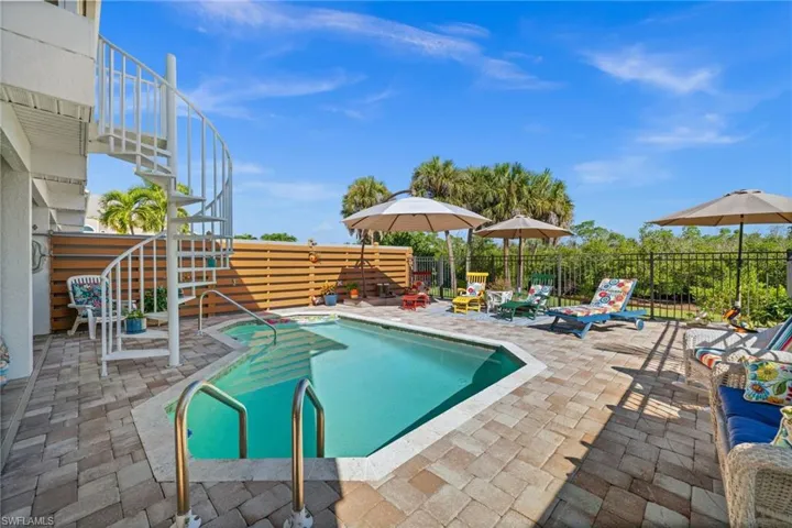 View of swimming pool featuring a patio area and stairway