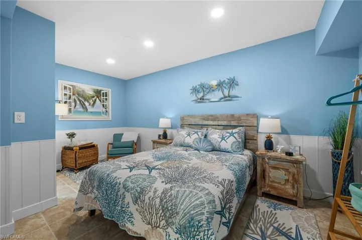 Bedroom featuring a wainscoted wall and recessed lighting