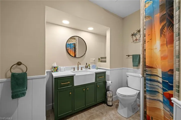 Full bathroom with vanity, a wainscoted wall, recessed lighting, and a shower with shower curtain