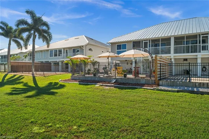 Back of house featuring a gazebo, a wooden deck, and a metal roof