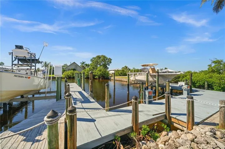 Dock featuring boat lift and a water view