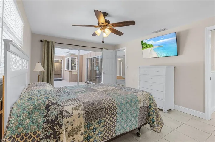 Bedroom featuring light tile patterned floors and ceiling fan