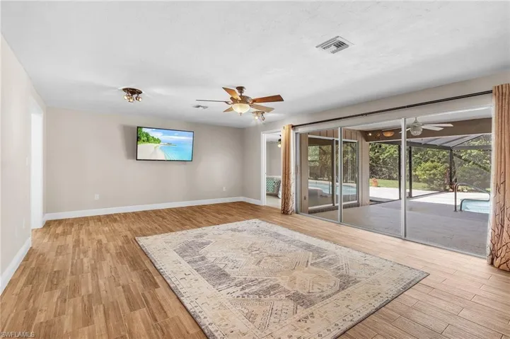 Unfurnished living room with a ceiling fan, light wood-style flooring, and healthy amount of natural light