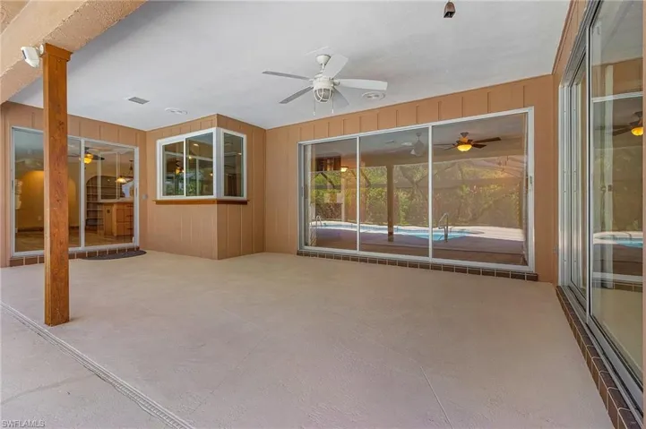 Unfurnished sunroom featuring ceiling fan