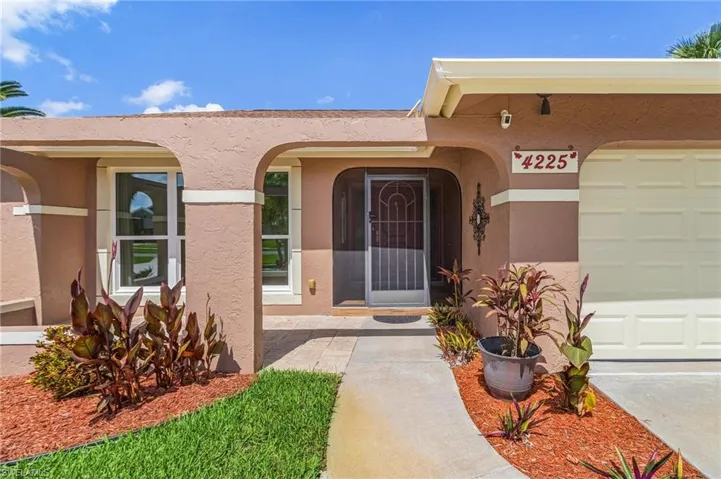 View of exterior entry with stucco siding