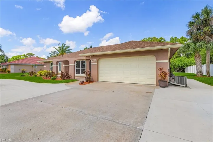 Single story home with driveway, stucco siding, and a garage