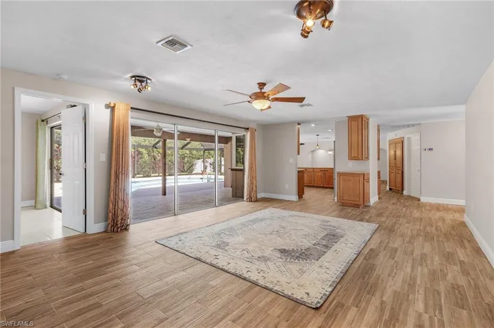 Unfurnished living room with a ceiling fan and light wood finished floors
