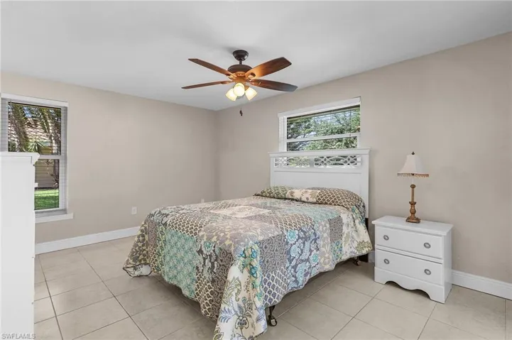 Bedroom with tile patterned flooring and a ceiling fan