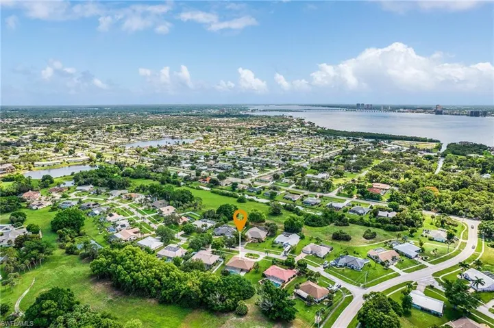 View of property location featuring a large body of water and nearby suburban area