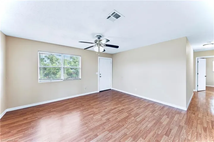 Empty room with ceiling fan and hardwood / wood-style floors