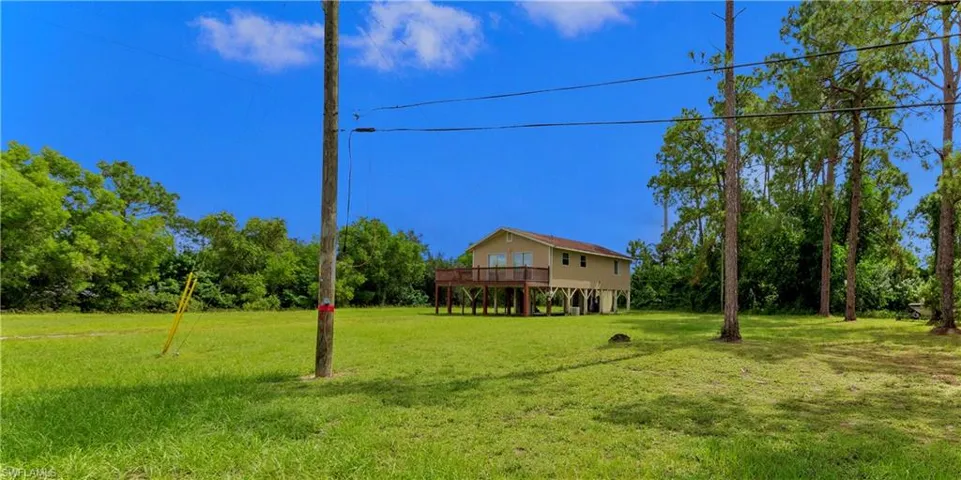 View of yard with a wooden deck