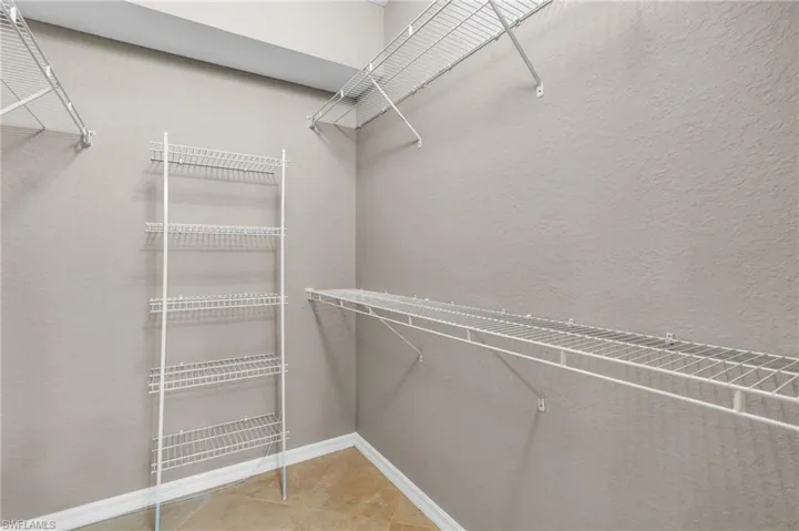 Walk in closet with tile patterned floors