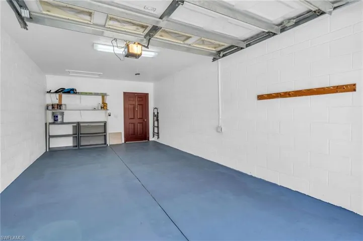 Garage with concrete block wall and a garage door opener