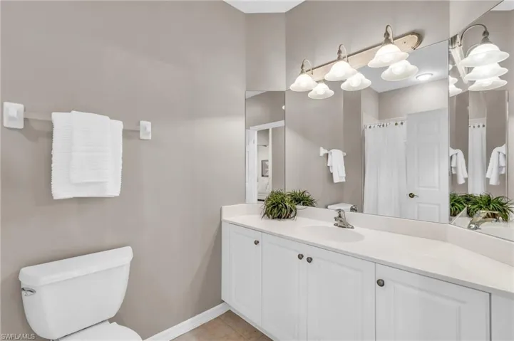 Bathroom featuring vanity, tile patterned floors, and a shower with curtain