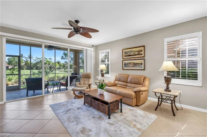 Living room with light tile patterned flooring and ceiling fan