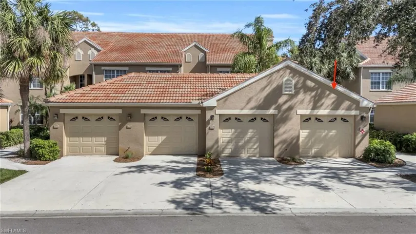 View of front of house featuring a tiled roof and stucco siding