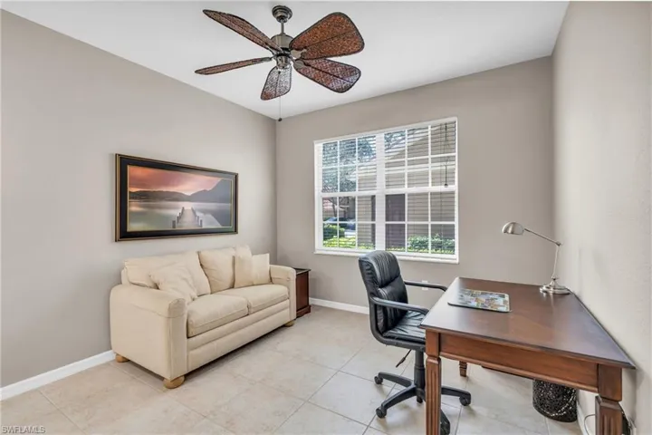 Home office featuring ceiling fan and light tile patterned floors