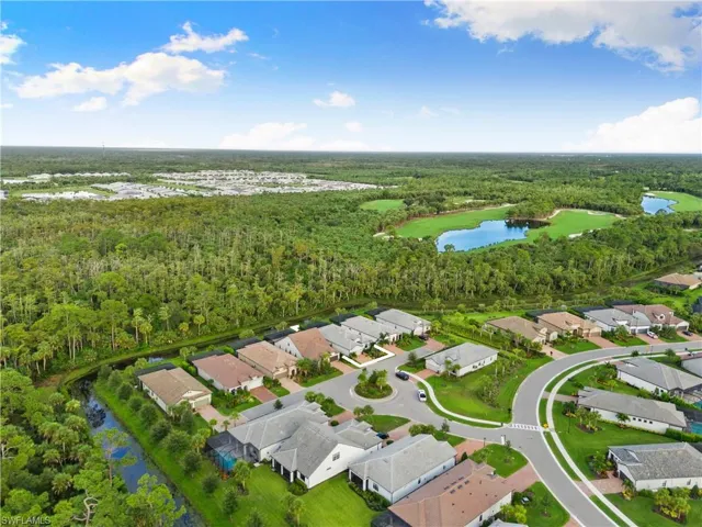Birds eye view of property with a water view