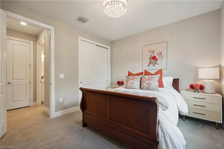 Carpeted bedroom with a closet