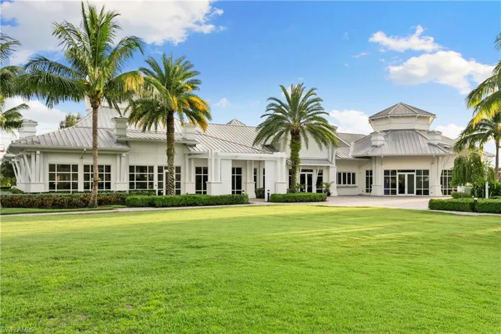 Back of property featuring a yard