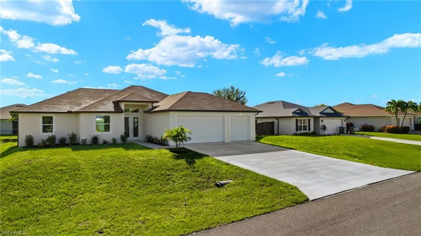 Ranch-style house with a front yard and a garage