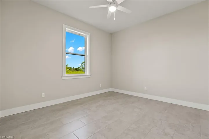 Unfurnished room featuring ceiling fan and light tile patterned floors