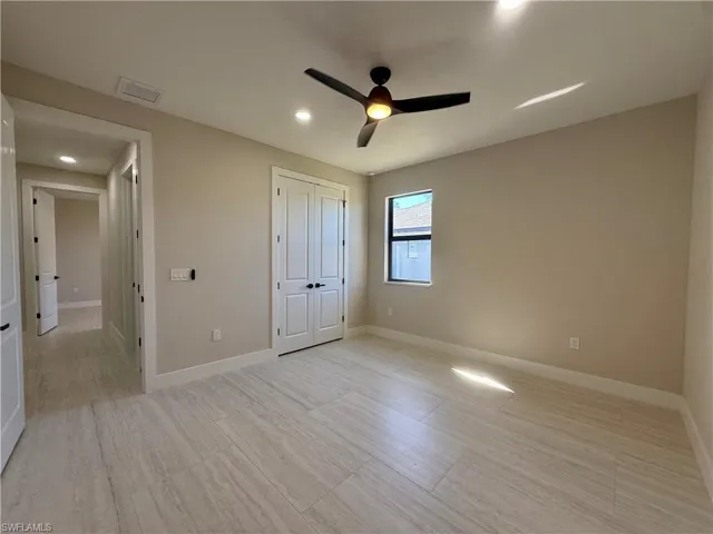 Unfurnished bedroom featuring a ceiling fan, a closet, recessed lighting, and light wood-style floors