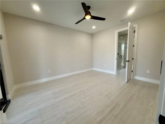 Empty room with a ceiling fan and recessed lighting