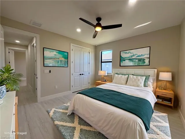 Bedroom with light wood-style flooring, a ceiling fan, a closet, and recessed lighting