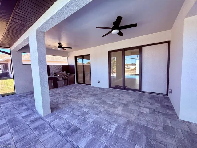 View of patio with ceiling fan and exterior kitchen