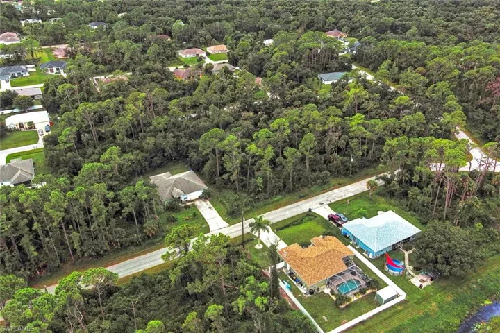 Aerial view of property's location featuring a forest