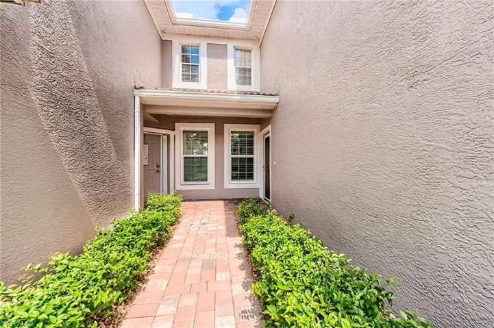 Doorway to property with stucco siding