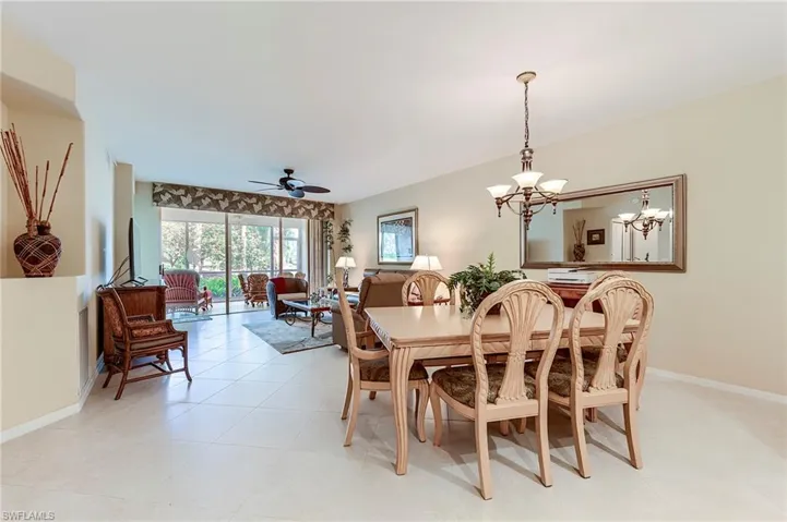 Dining space with a chandelier, ceiling fan, and baseboards