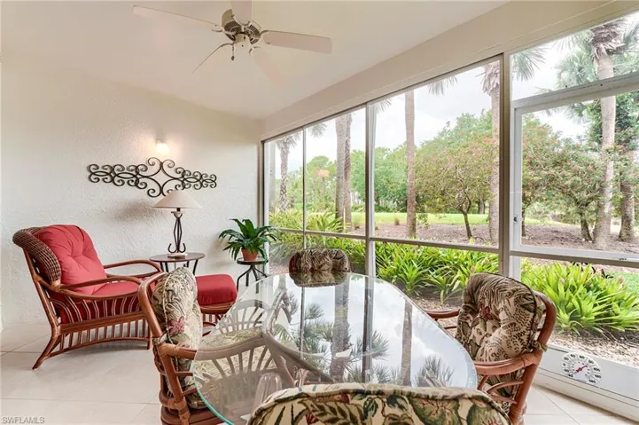 Sunroom featuring ceiling fan and outdoor dining space