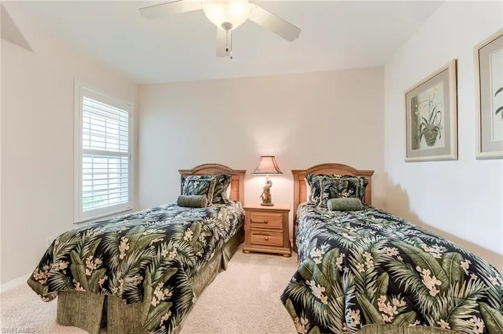 Bedroom featuring light carpet and ceiling fan